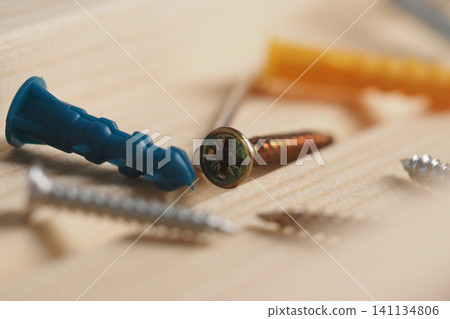 Tools and screws on wooden surface during a project Tools and screws on wooden surface during a project 141134806