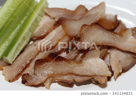 Grilled Sliced Pork Neck Served with Fresh Cucumber Close-Up Grilled Sliced Pork Neck Served with Fresh Cucumber Close-Up 141134831