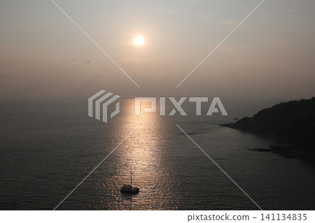 Sailboat Silhouette on Calm Sea at Golden Sunset with Island Sailboat Silhouette on Calm Sea at Golden Sunset with Island 141134835