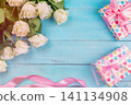 beautiful white roses on a blue wooden background. place for text. top view background 141134908