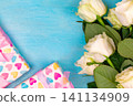 beautiful white roses on a blue wooden background. place for text. top view background 141134909