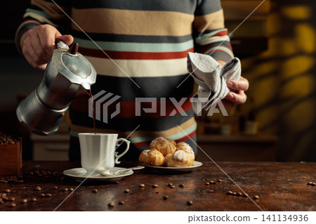 Profiteroles with mascarpone and cup of black coffee. Profiteroles with mascarpone and cup of black coffee. 141134936