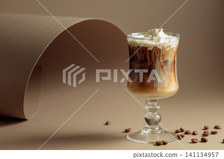 Cream and coffee cocktail on beige background. Cream and coffee cocktail on beige background. 141134957