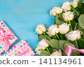 beautiful white roses on a blue wooden background. place for text. top view background 141134961