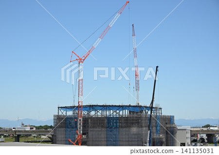 Blue sky, building under construction, and large crane 1 141135031