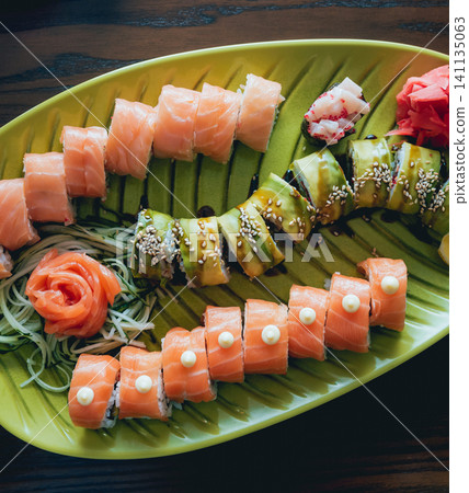 Sushi and rolls with salmon, prawn, avocado, cream cheese. Sushi menu. Japanese food. Sushi and rolls with salmon, prawn, avocado, cream cheese. Sushi menu. Japanese food. 141135063