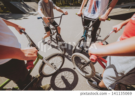 Bmx riders performing tricks at skatepark. Bmx riders performing tricks at skatepark. 141135069