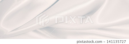 Smooth elegant grey silk or satin luxury cloth as wedding background. Luxurious Christmas background or New Year background design Smooth elegant grey silk or satin luxury cloth as wedding background. Luxurious Christmas background or New Year background design 141135727