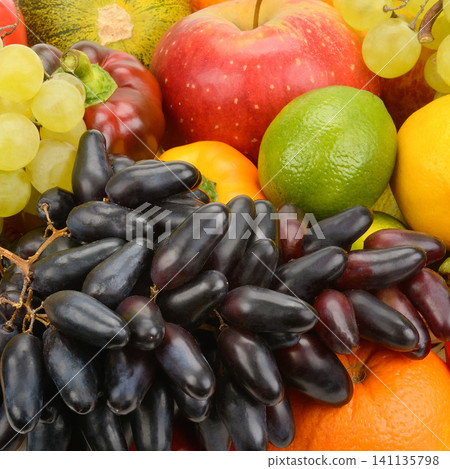 Close Up Assortment of Fresh Fruits and Vegetables for Healthy Diet Vibrant Mix of Organic Grapes Apples Lime and Oranges Background Close Up Assortment of Fresh Fruits and Vegetables for Healthy Diet Vibrant Mix of Organic Grapes Apples Lime and Oranges Background 141135798