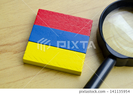 Colorful wooden blocks with a magnifying glass on a wooden surface representing learning and discovery Colorful wooden blocks with a magnifying glass on a wooden surface representing learning and discovery 141135954