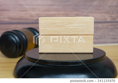 Stacked Wooden Blocks on Round Base Beside Horizontal Gavel Stacked Wooden Blocks on Round Base Beside Horizontal Gavel 141135970