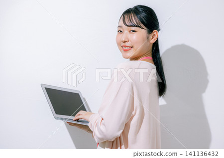 Woman using a laptop 141136432