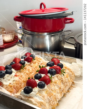 Meringue rolls with strawberries, blueberries, and whipped cream Meringue rolls with strawberries, blueberries, and whipped cream 141137202