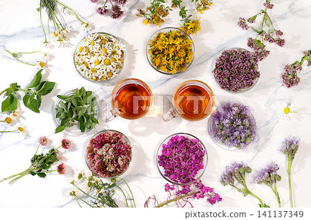 Collection of useful herbs for treatment according to folk recipes,Medicinal herbs and their flower petals in glass cups for infusions or tea, concept of alternative folk medicine, Collection of useful herbs for treatment according to folk recipes,Medicinal herbs and their flower petals in glass cups for infusions or tea, concept of alternative folk medicine, 141137349