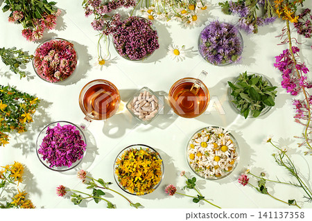 Collection of useful herbs for treatment according to folk recipes,Medicinal herbs and their flower petals in glass cups for infusions or tea, concept of alternative folk medicine, Collection of useful herbs for treatment according to folk recipes,Medicinal herbs and their flower petals in glass cups for infusions or tea, concept of alternative folk medicine, 141137358
