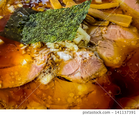 Authentic soy sauce ramen featuring a flavorful broth and outstanding char siu pork. Authentic soy sauce ramen featuring a flavorful broth and outstanding char siu pork. 141137391