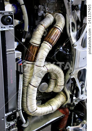 The exhaust manifold/exhaust pipe of a horizontally opposed engine has been wrapped in heat-resistant (thermo-bandage) to improve exhaust efficiency. The exhaust manifold/exhaust pipe of a horizontally opposed engine has been wrapped in heat-resistant (thermo-bandage) to improve exhaust efficiency. 141137405