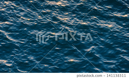Glistening and shimmering blue ocean surface background with sun reflections Glistening and shimmering blue ocean surface background with sun reflections 141138311