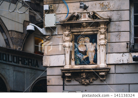 Madonna shrine on the facade of the old house in Genoa, Italy Madonna shrine on the facade of the old house in Genoa, Italy 141138324