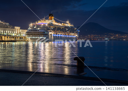 NAPLES, ITALY - NOV 5, 2018: Big white Costa Fascinosa cruise ship docked at the port of Naples at night NAPLES, ITALY - NOV 5, 2018: Big white Costa Fascinosa cruise ship docked at the port of Naples at night 141138665