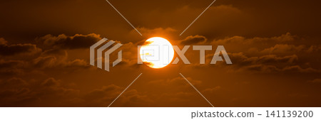 Beatiful sunset above the mediterranean sea. Sunrise with red and orange skies and the sun shining. Bright sun with dark background Beatiful sunset above the mediterranean sea. Sunrise with red and orange skies and the sun shining. Bright sun with dark background 141139200