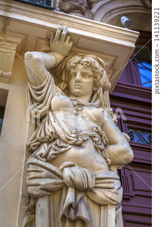 Marseille, France - Nov 03 2018, vertical close up view of the caryatid sculpture adorning the facade of one of the ancient buildings of Marseille, France Marseille, France - Nov 03 2018, vertical close up view of the caryatid sculpture adorning the facade of one of the ancient buildings of Marseille, France 141139221