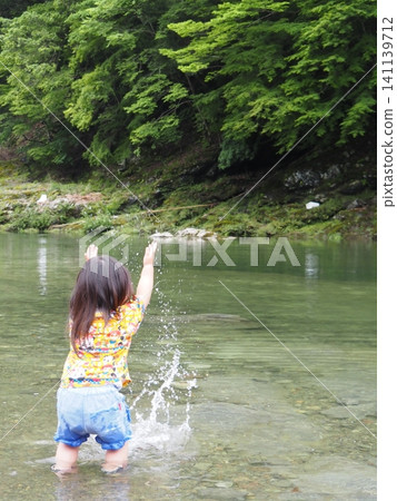 Girls playing on the river 141139712