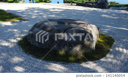 A large stone placed in a dry landscape garden by the sea. A large stone placed in a dry landscape garden by the sea. 141140054