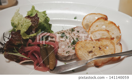 An appetizer platter combining pâté, salad, and toast. An appetizer platter combining pâté, salad, and toast. 141140059