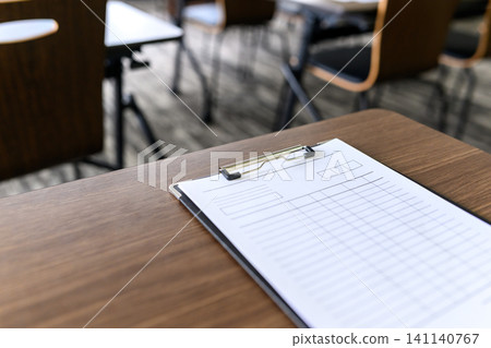 Clipboard placed on the table Clipboard placed on the table 141140767