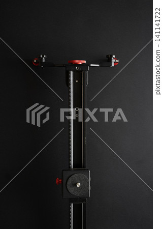 Macro rail slider for camera photography close-up with precise manual adjustment on black background Macro rail slider for camera photography close-up with precise manual adjustment on black background 141141722