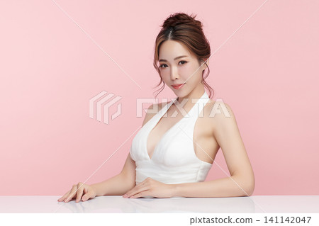 A beautiful young Asian woman with clean, fresh skin against a pink background. Skincare, facial treatment, cosmetology, beauty, and spa. An elegant portrait of an Asian woman. A beautiful young Asian woman with clean, fresh skin against a pink background. Skincare, facial treatment, cosmetology, beauty, and spa. An elegant portrait of an Asian woman. 141142047