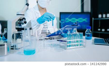 Professional scientists conduct genetic research and DNA analysis using advanced technology in a modern laborator Professional scientists conduct genetic research and DNA analysis using advanced technology in a modern laborator 141142990
