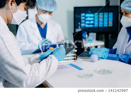 Scientists conducting laboratory research, analyzing samples in a biotech lab. Healthcare innovation, medical testing, and advanced science technology 141142997