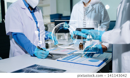 Team of medical scientists analyzing digital lung x-ray and patient data with futuristic healthcare technology interface in laboratory Team of medical scientists analyzing digital lung x-ray and patient data with futuristic healthcare technology interface in laboratory 141143042