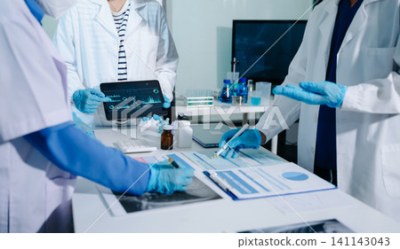 Professional female doctor using futuristic AI digital interface for patient health monitoring and diagnostic analysis in laboratory Professional female doctor using futuristic AI digital interface for patient health monitoring and diagnostic analysis in laboratory 141143043