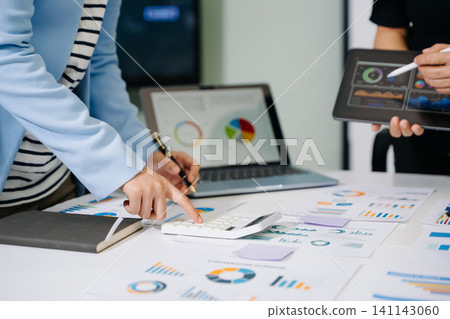Businessman and team analyzing financial statement Finance task. with smart phone and laptop and tablet. Wealth management concept. Businessman and team analyzing financial statement Finance task. with smart phone and laptop and tablet. Wealth management concept. 141143060