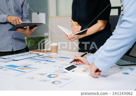 Businessman and team analyzing financial statement Finance task. with smart phone and laptop and tablet. Wealth management concept Businessman and team analyzing financial statement Finance task. with smart phone and laptop and tablet. Wealth management concept 141143062