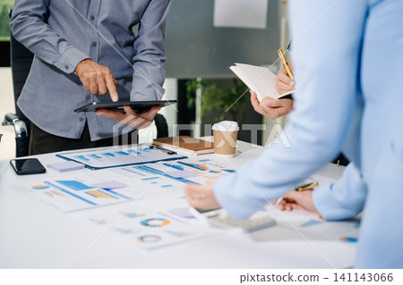 Businessman and team analyzing financial statement Finance task. with smart phone and laptop and tablet. Wealth management concept Businessman and team analyzing financial statement Finance task. with smart phone and laptop and tablet. Wealth management concept 141143066