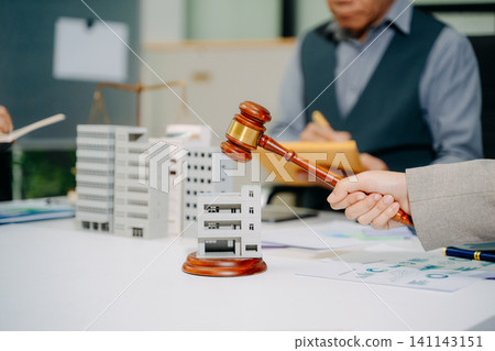 Real estate legal consultation with gavel and property models, highlighting investment, contracts, negotiation, and property law Real estate legal consultation with gavel and property models, highlighting investment, contracts, negotiation, and property law 141143151