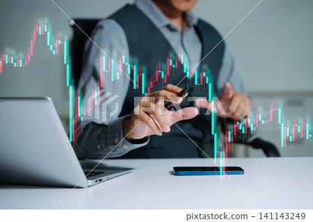 Attractive young european businessman using laptop with abstract forex chart. Investment and economy concept. Attractive young european businessman using laptop with abstract forex chart. Investment and economy concept. 141143249
