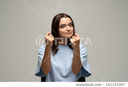 Woman making money gesture with both hands, expressing desire for wealth, payment, profit, asking for cash Woman making money gesture with both hands, expressing desire for wealth, payment, profit, asking for cash 141143367