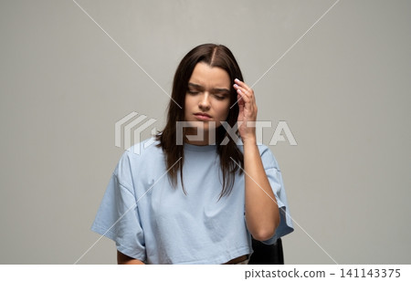 Young woman experiencing severe headache or migraine, feeling tired, stressed, suffering from pain and health issues Young woman experiencing severe headache or migraine, feeling tired, stressed, suffering from pain and health issues 141143375