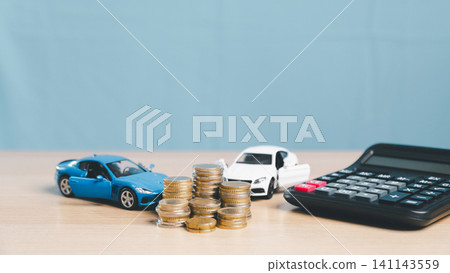 Toy cars, coin stacks, and calculator on desk with copy space, representing auto finance comparison, car insurance, vehicle loan payment, purchase planning, and transportation cost. Toy cars, coin stacks, and calculator on desk with copy space, representing auto finance comparison, car insurance, vehicle loan payment, purchase planning, and transportation cost. 141143559