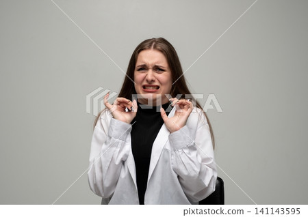 Young woman showing disgust, aversion, and revulsion emotion with a negative facial expression and hand gesture Young woman showing disgust, aversion, and revulsion emotion with a negative facial expression and hand gesture 141143595