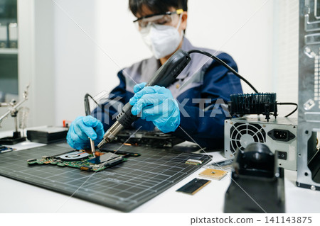 expert soldering a green PCB board using precision tools. Ideal for electronics, circuit repair, engineering, tech expert soldering a green PCB board using precision tools. Ideal for electronics, circuit repair, engineering, tech 141143875