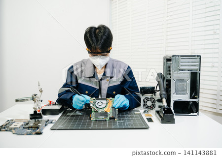 expert soldering a green PCB board using precision tools. Ideal for electronics, circuit repair, engineering, tech expert soldering a green PCB board using precision tools. Ideal for electronics, circuit repair, engineering, tech 141143881