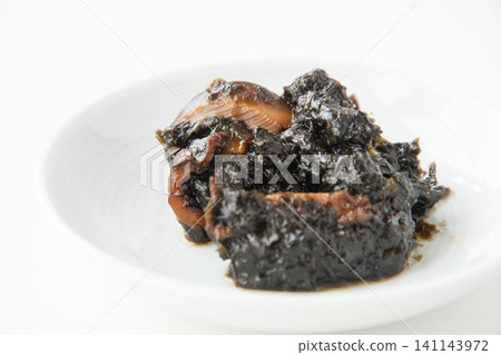 Freshly made seaweed tsukudani served on a small white plate. Freshly made seaweed tsukudani served on a small white plate. 141143972