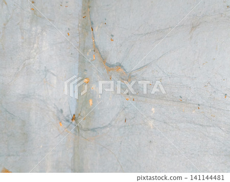 Abstract background of a weathered and distressed wall with peeling paint and plaster in faded light blue and beige tones, showcasing aged texture and grunge details. Abstract background of a weathered and distressed wall with peeling paint and plaster in faded light blue and beige tones, showcasing aged texture and grunge details. 141144481
