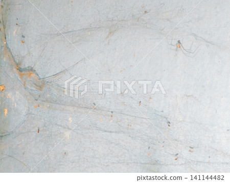 Abstract background of a weathered and distressed wall with peeling paint and plaster in faded light blue and beige tones, showcasing aged texture and grunge details. Abstract background of a weathered and distressed wall with peeling paint and plaster in faded light blue and beige tones, showcasing aged texture and grunge details. 141144482